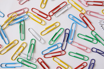Fototapeta na wymiar Colored paper clips close-up on a white background
