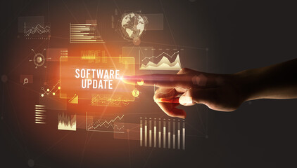 Hand touching SOFTWARE UPDATE inscription, new business technology concept