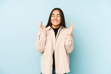 Young woman isolated on a blue background joyful laughing a lot. Happiness concept.