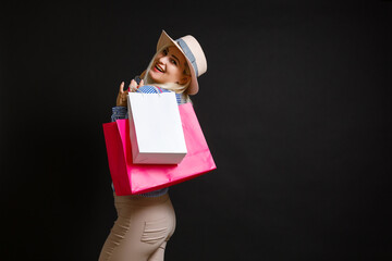 Elegant woman holding shopping bags, black friday concept