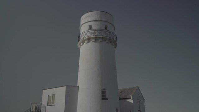 beautiful white lighthouse building in the coast of hunstanton england with blue sky