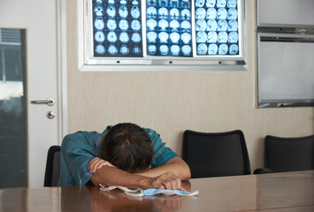 A doctor feels tired in medical office