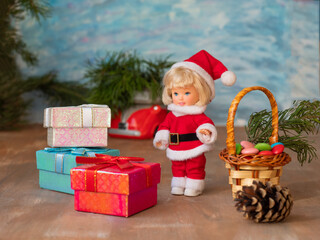 Young Santa with boxes with gifts and a basket of sweets