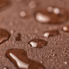 A natural stone covered with a protective liquid from moisture and mold. Protect the stone from moisture. Drops of water on a rock. Hydrophobicity.