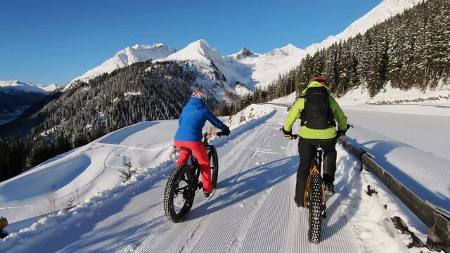 Mountain biking in the snow with awesome landscape in Tirol. Mtb bith fatbike snow.