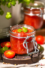 Tomato salsa in a glass jar.