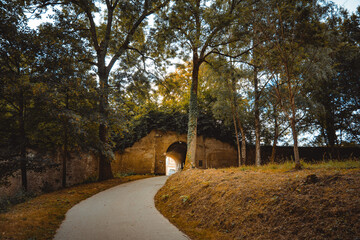 Brick tunnel at the edge of the park in autumn