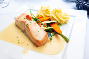 grilled salmon and lemon - french cuisine dish with tomato and salmon