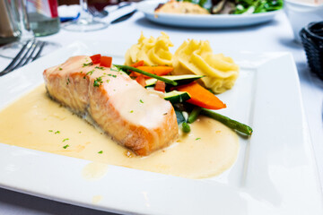grilled salmon and lemon - french cuisine dish with tomato and salmon