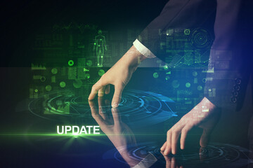 Businessman touching huge display with UPDATE inscription, modern technology concept