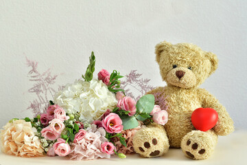 bouquet of delicate pink flowers and present box.Teddy bear. Valentines Day 14 February.Greeting card for Birthday, Woman or Mothers Day. I love you concept.Good morning.Selective focus.Copy space.