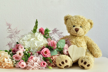 bouquet of delicate pink flowers and present box.Teddy bear. Valentines Day 14 February.Greeting card for Birthday, Woman or Mothers Day. I love you concept.Good morning.Selective focus.Copy space.