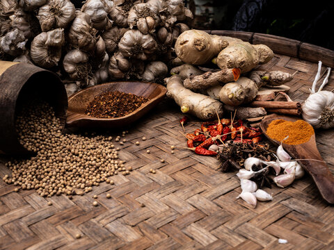 colourful spices in wooden tray. Asian popular cooking ingredients, dry hot healthy cook herbs. view form above and copy space background.