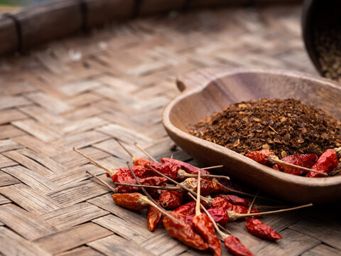 colourful spicy chilis in wooden tray. Asian popular cooking ingredients, dry hot healthy cook herbs. view form above and copy space background.