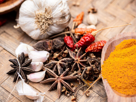 Top view of colourful spices in wooden tray. Asian popular cooking ingredients, dry hot healthy asian cook herbs. view form above and copy space background.