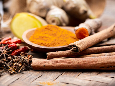 colourful spices cinnamon in wooden tray. Asian popular cooking ingredients, dry hot healthy cook herbs. view form above and copy space background.