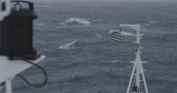 Flag on the ship blowing in the storm