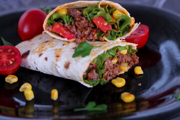 Tortilla wraps sandwiches with fresh vegetables, minced meat and on marble background. Burrito, sandwich wrap, fajita wrap