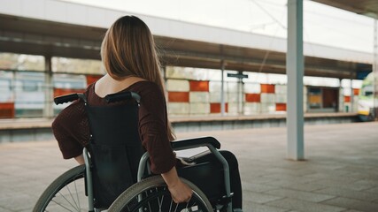 Fototapeta na wymiar Happy young independent disabled woman on the train station. High quality photo