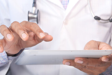 doctor in white coat is using a digital tablet