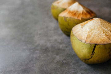 The young coconut is tasty for drinking juice on stone background copy space
