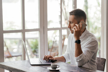 young man working on his computer at the cafe. business, freelance