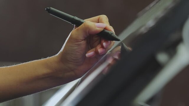 Drawing on a graphics tablet. The designer draws on a graphics tablet. Working with interactive pen display. closeup. Wallpaper production.