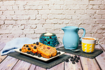 Still life of wild fruit cake with cup of milk with cocoa and milk jug.