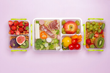 School lunch box with set of fruits, berries vegetables, ham