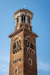 Fototapeta na wymiar Verona. Closeup of the Torre dei Lamberti, medieval tower (XI century-1403), Piazza delle Erbe, UNESCO heritage site, Veneto, Italy, Europe.