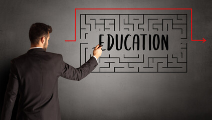 businessman drawing maze with EDUCATION inscription, business education concept