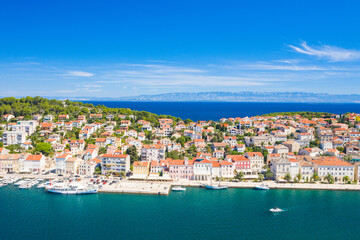 Fototapeta na wymiar Aerial view of the seafront in town of Mali Losinj on the island of Losinj, Adriatic coast in Croatia, Velebit mountain in background