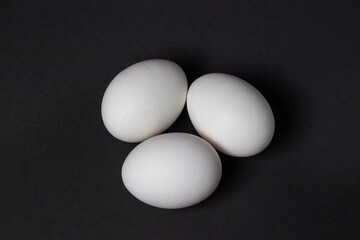 Eggs on a black background. White chicken eggs