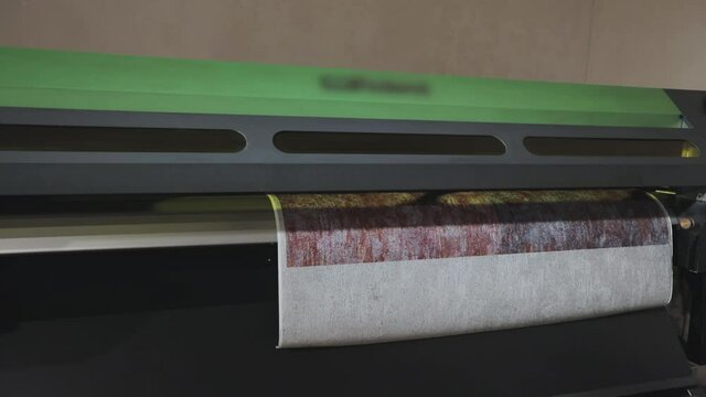 Modern wallpaper factory. Industrial printer making new wallpaper sample. Wallpaper production. One of step creation new wallpaper. Closeup