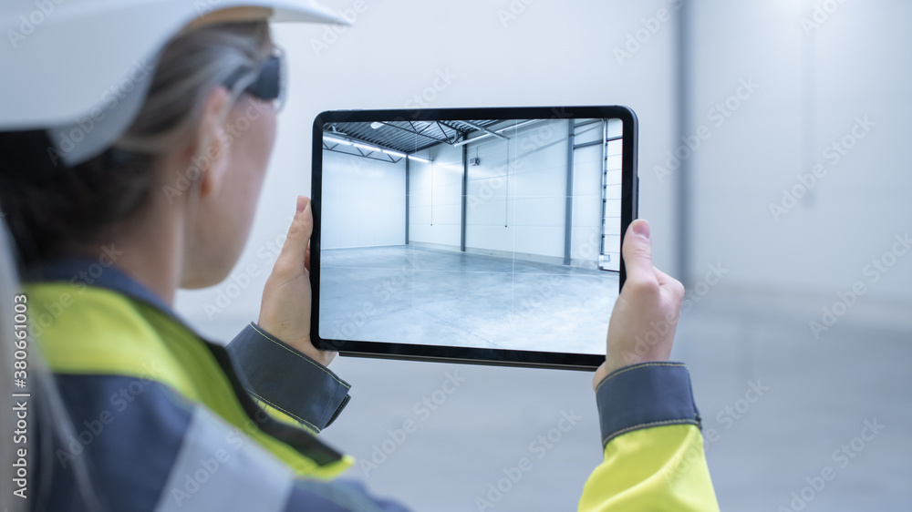 Poster Industry 4.0 Modern Factory: Female Engineer Uses Digital Tablet Computer with Augmented Reality Software Visualizing of Manufacturing Plant Room Mapping, Factory Layout. Concept Shot Suitable for AR.