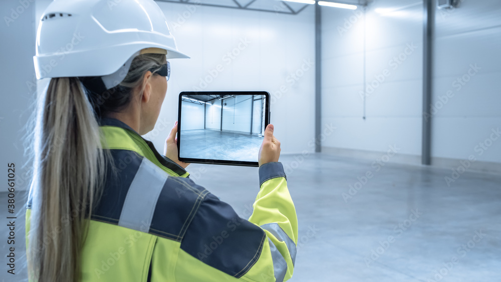 Poster Industry 4.0 Modern Factory: Female Engineer Uses Digital Tablet Computer with Augmented Reality Software Visualizing of Manufacturing Plant Room Mapping, Factory Layout. Concept Shot Suitable for AR.