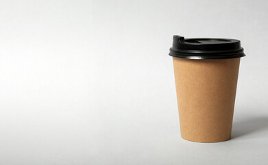 Takeaway paper coffee cup on light grey background. Space for text
