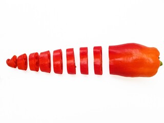 Red fresh pepper cut into equal parts of the ring on a white background.