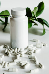 Collagen in capsules and white bottle, monochrome beauty concept. 