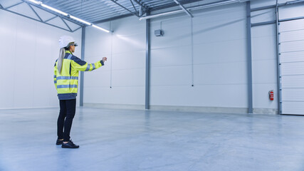 Industry 4.0 Modern Factory: Female Engineer Wearing Augmented Reality Headset Uses Mixed Reality Software and Gestures for Mapping Manufacturing Plant Floor for Future Machinery, Factory Floor Layout