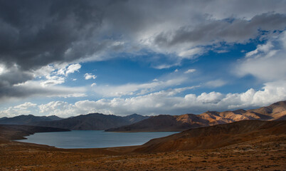 Fototapeta premium Central Asia. Tajikistan. A picturesque lake with swampy shores in a deserted mountain valley along the Pamir highway.