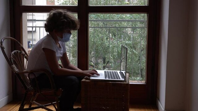Europe, Italy , Milan - children boy  five years with mask and father at home during quarantine due n-cov19 Coronavirus outbreak - life stile in apartment, school lesson with lap to