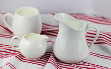 three white mik jugs