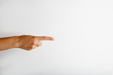 Female hand pointing from side to free space for text on white background