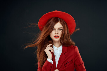 Pretty woman with red lips hat on her head jacket elegant style charm dark isolated background