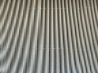 White color aluminium metal plate Siding. Seamless surface of galvanize steel. Industrial building wall made of corrugated metal sheet, flat background photo texture