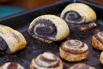 Baked buns stuffed with poppy, cinnamon and walnuts. Lie on a baking sheet. Cooking buns.