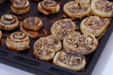 Baked buns stuffed with poppy, cinnamon and walnuts. Lie on a baking sheet. Cooking buns.