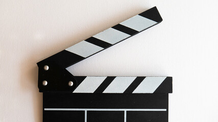 Close up of a wooden black clapperboard isolated on white background. Cinematography production...