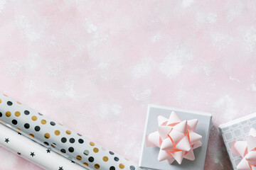 Christmas and New Year holiday background or greeting card. Gray white gift boxes with pink bows. 